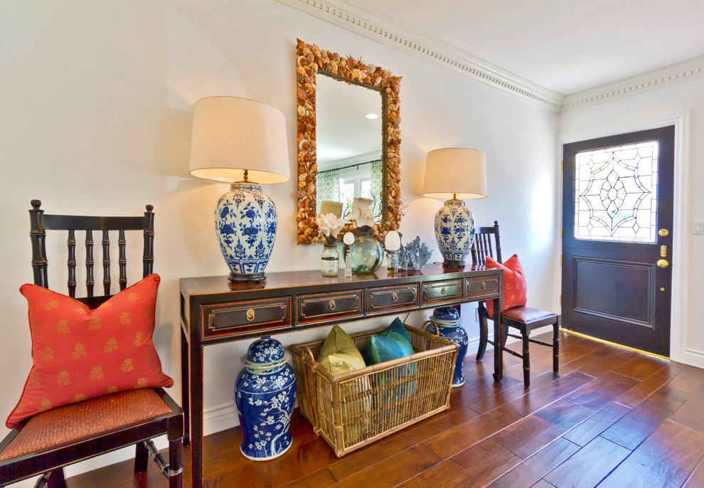 Example of an eclectic single front door design in Orange County with a dark wood front door