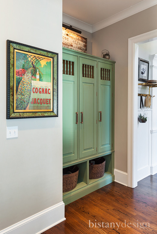 Example of a mid-sized classic medium tone wood floor entry hall design in Charlotte with gray walls