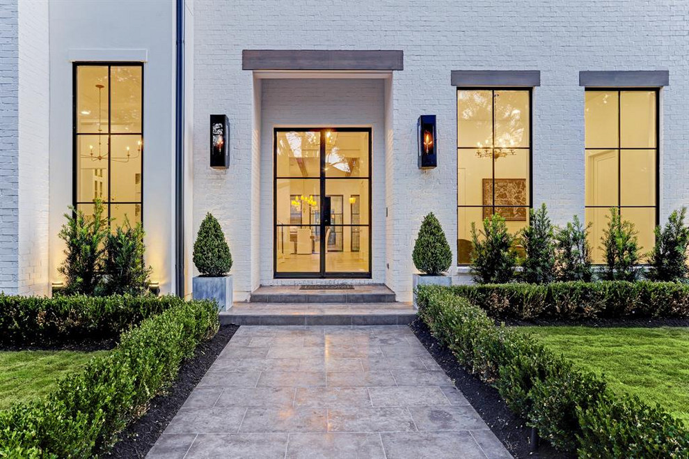 Photo of a classic front door in Houston with white walls, concrete flooring, a double front door and a glass front door.