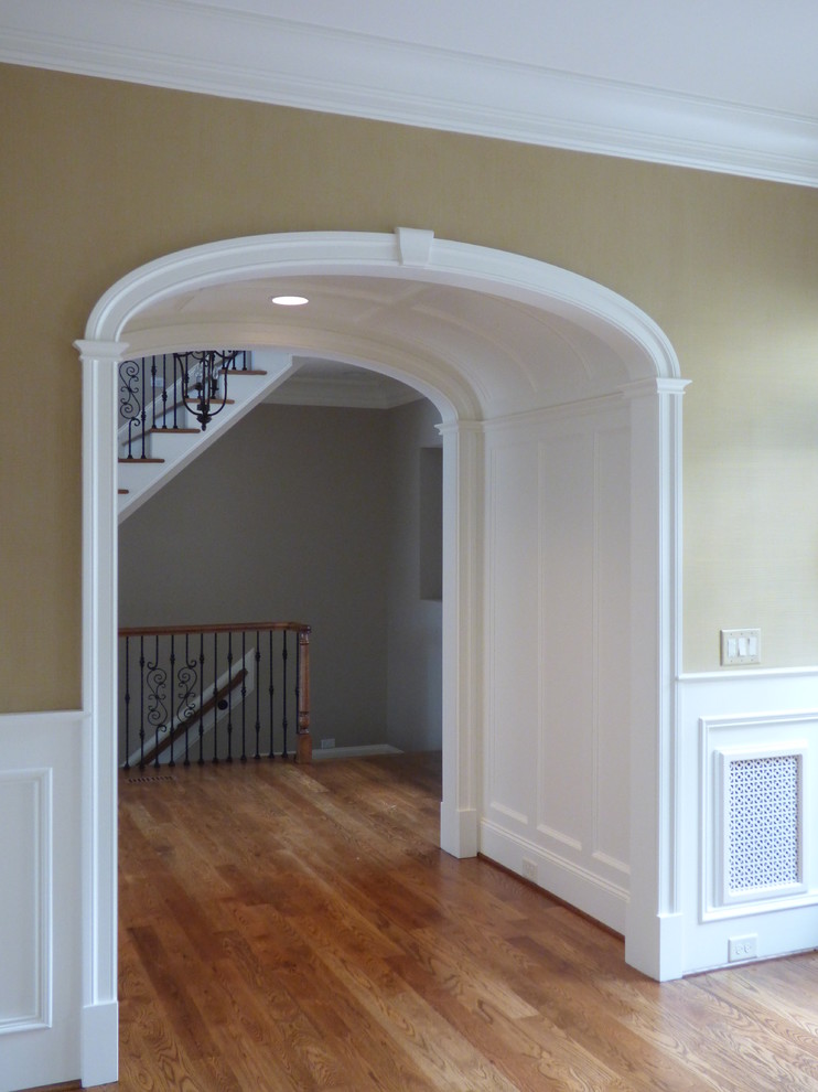 Example of a large medium tone wood floor foyer design in Raleigh