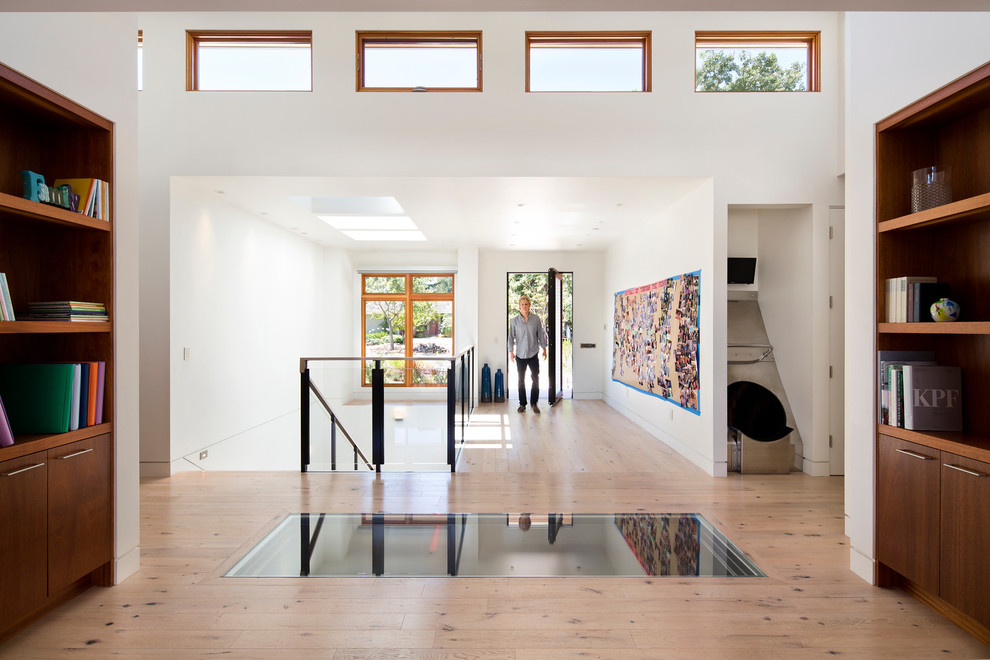 Contemporary foyer in San Francisco with white walls and light hardwood flooring.
