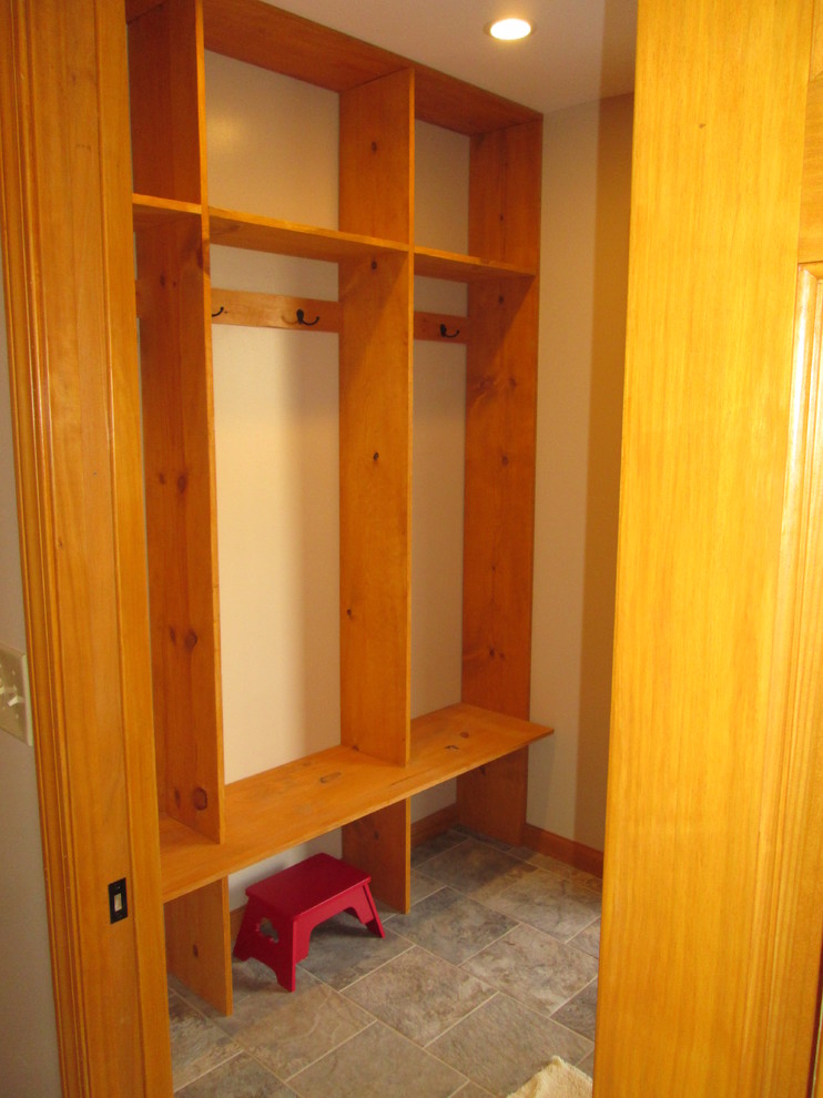 Example of a mid-sized farmhouse ceramic tile entryway design in Indianapolis with beige walls and a white front door