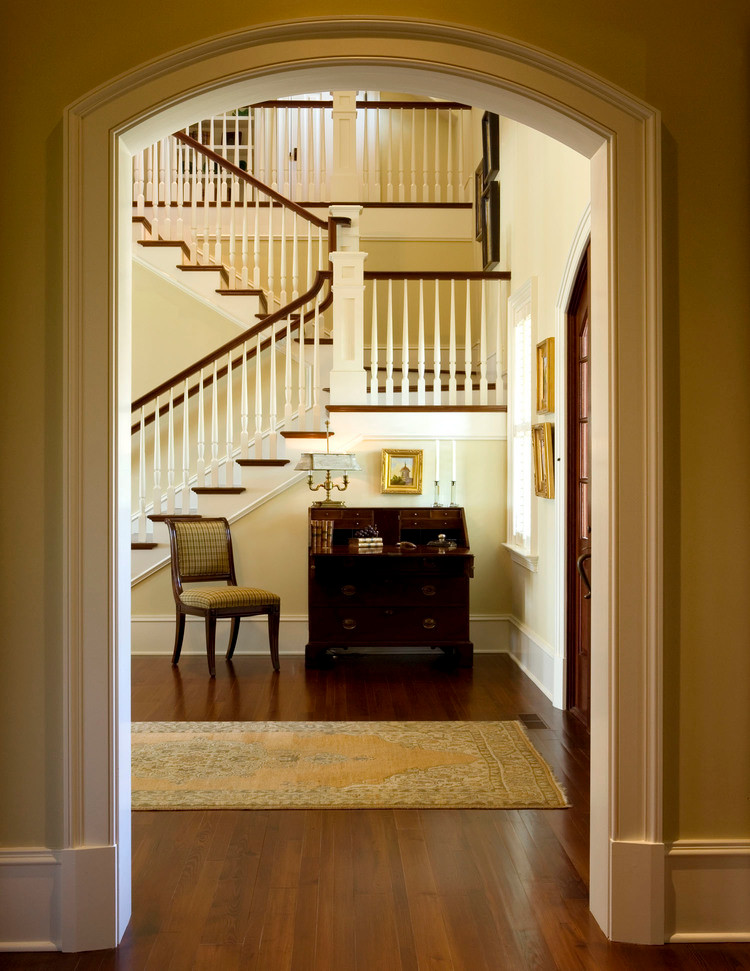 Inspiration for a large classic foyer in Charleston with yellow walls, medium hardwood flooring, a double front door and a dark wood front door.