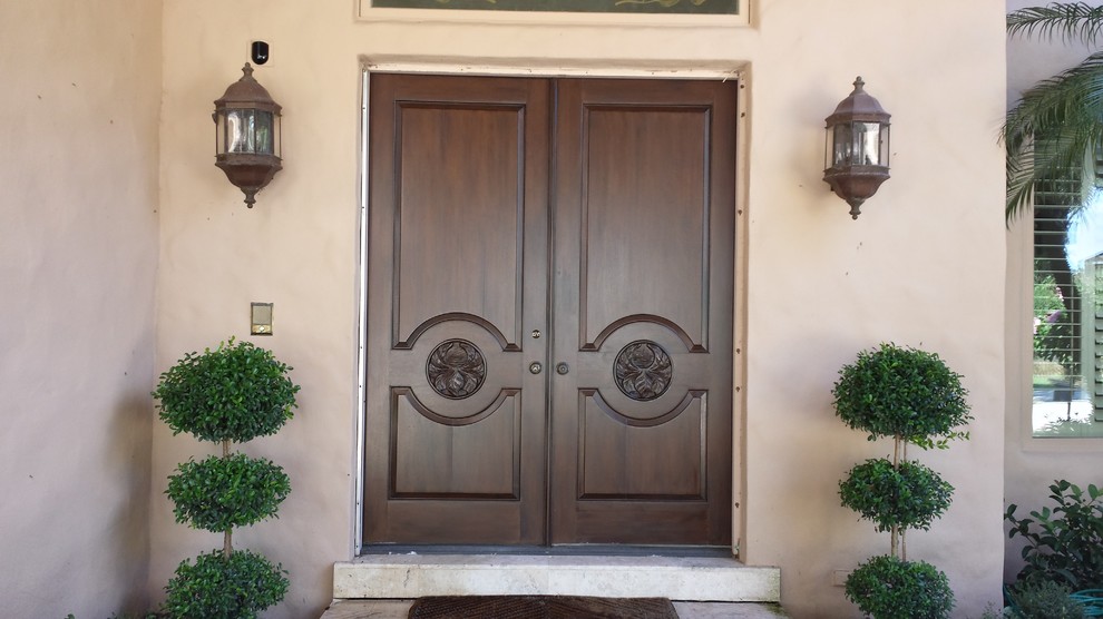 Ejemplo de puerta principal mediterránea de tamaño medio con puerta doble y puerta de madera oscura