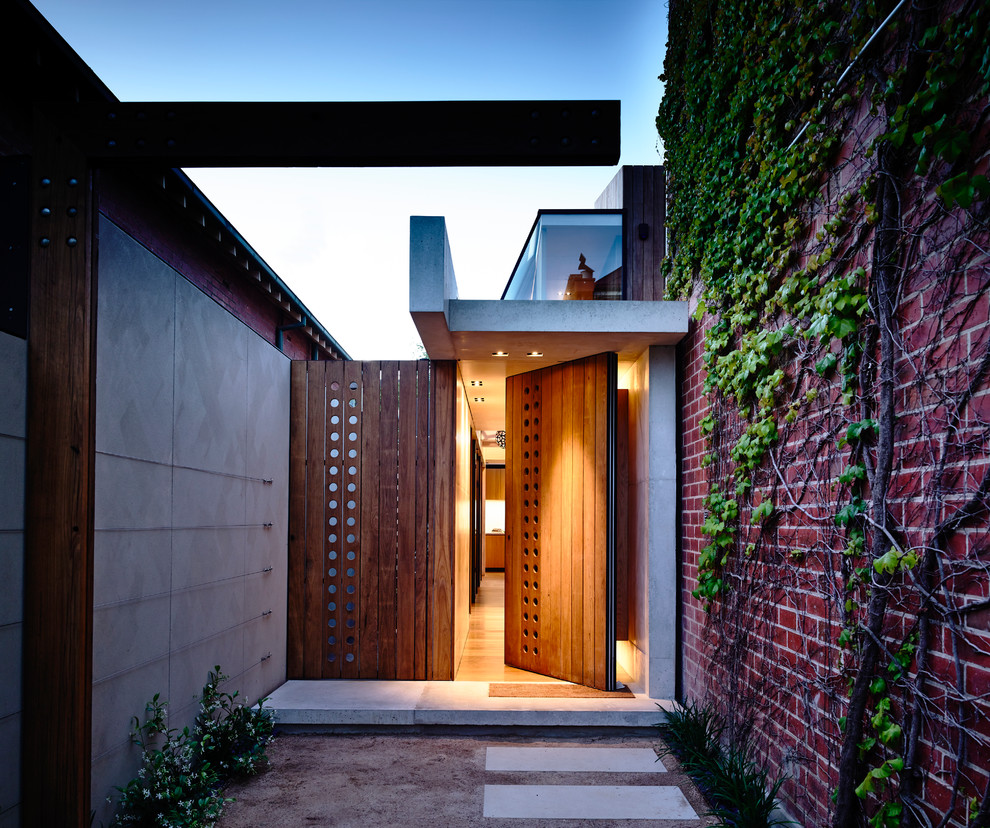 This is an example of a contemporary front door in Melbourne with a single front door and a medium wood front door.