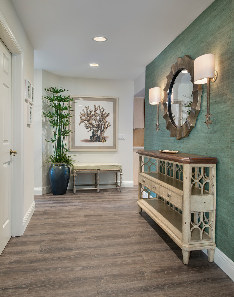 Example of a mid-sized beach style medium tone wood floor and brown floor foyer design in Miami with multicolored walls