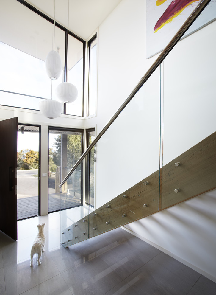 Inspiration for a large coastal porcelain tile entryway remodel in Melbourne with white walls and a brown front door