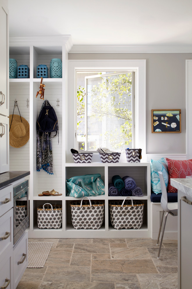 Large beach style limestone floor mudroom photo in New York with gray walls
