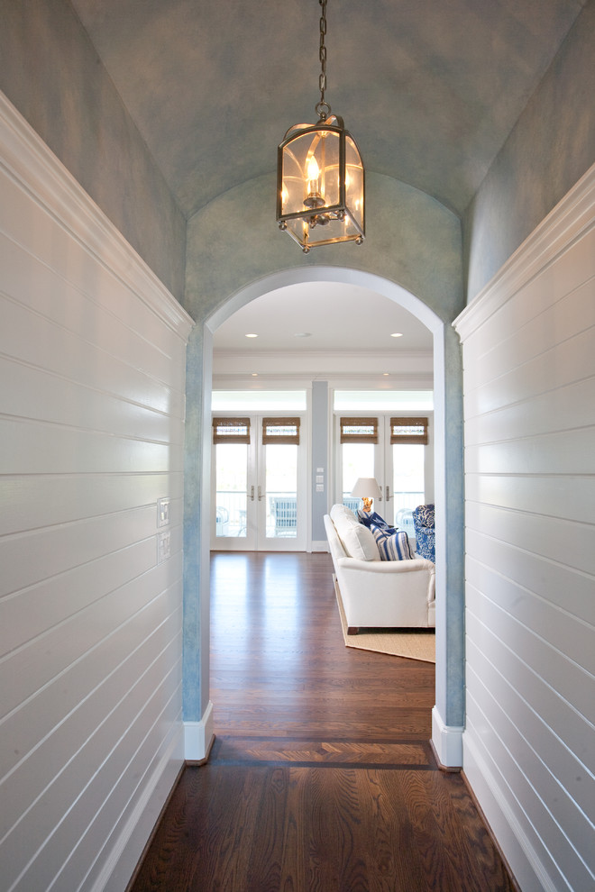 Example of a large classic dark wood floor entryway design in Houston with white walls and a white front door