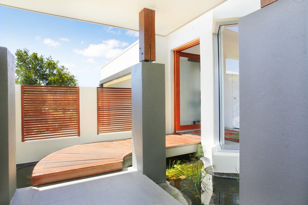 Example of a trendy entryway design in Sunshine Coast with a glass front door