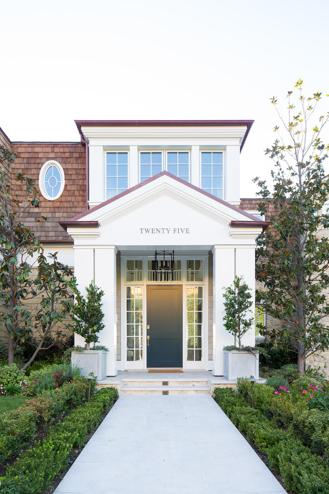 Photo of a beach style front door in Orange County with white walls, a stable front door, a blue front door and grey floors.