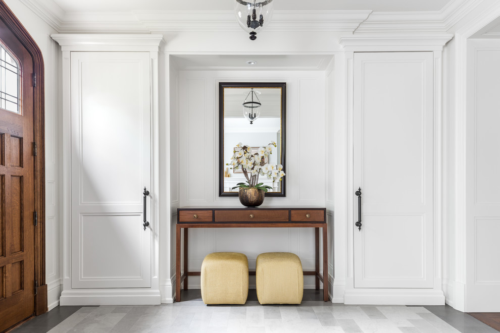 Design ideas for a large traditional foyer in Toronto with grey walls, marble flooring, a single front door and a medium wood front door.