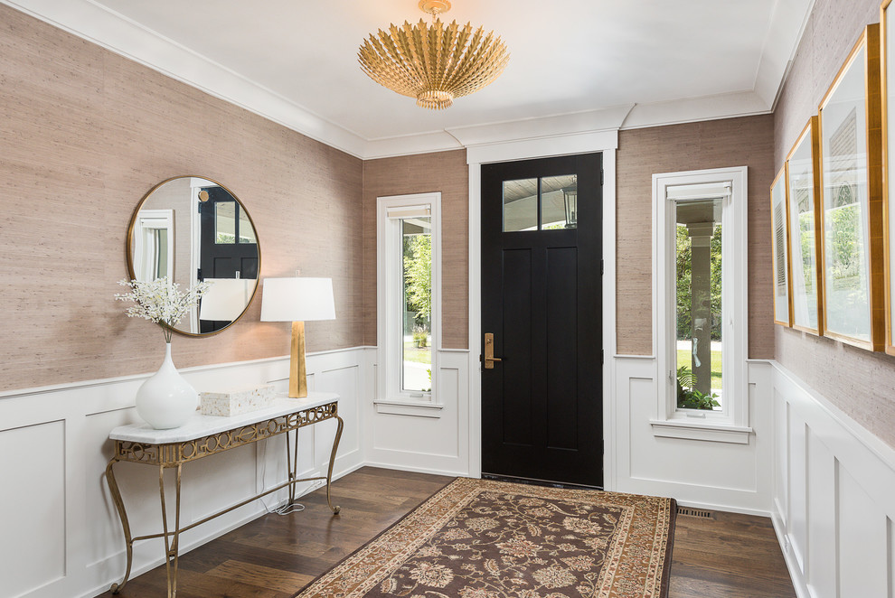 Inspiration for a classic foyer in Chicago with beige walls, dark hardwood flooring, a single front door, a black front door, brown floors and feature lighting.
