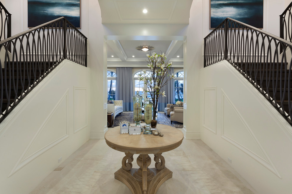 Inspiration for a huge timeless marble floor and beige floor entry hall remodel in Miami with beige walls