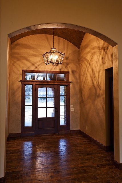 Diseño de distribuidor campestre de tamaño medio con paredes beige, suelo de madera oscura, puerta simple y puerta de madera oscura