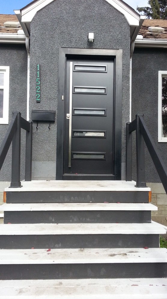 Ispirazione per una porta d'ingresso moderna di medie dimensioni con una porta singola e una porta nera