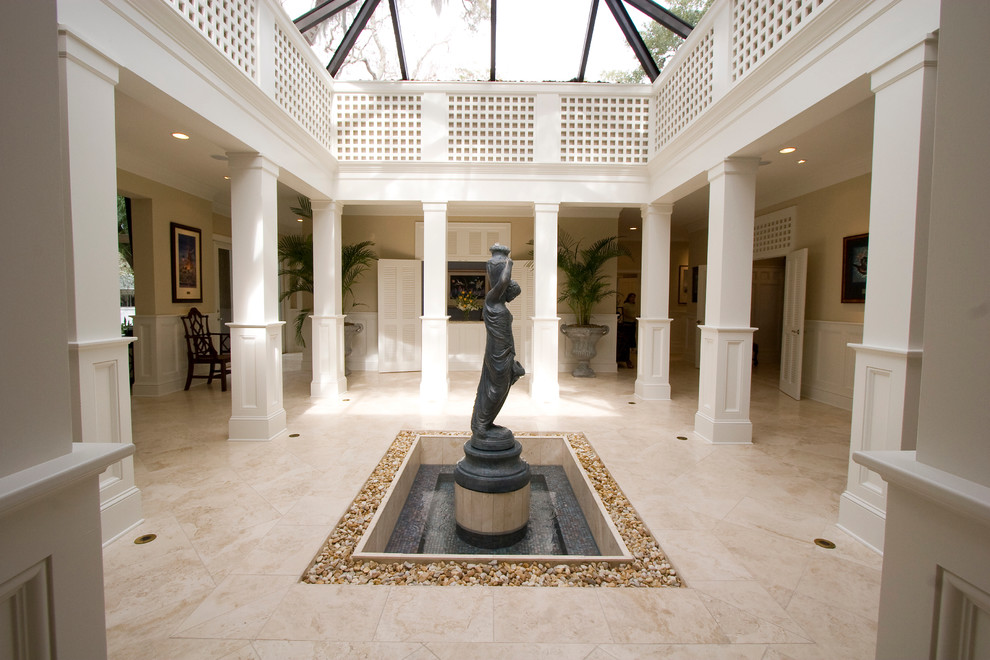 Inspiration for a medium sized traditional foyer in Tampa with beige walls, travertine flooring and beige floors.