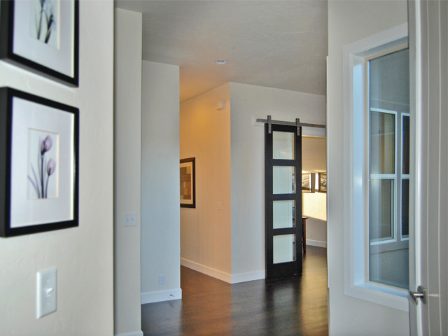Example of a mid-sized trendy dark wood floor entryway design in Boise with beige walls and a white front door