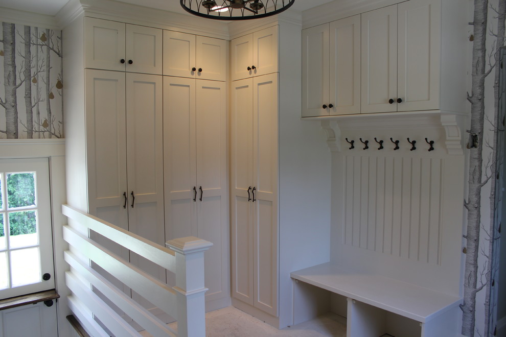 Elegant mudroom photo in Boston with white walls and a white front door