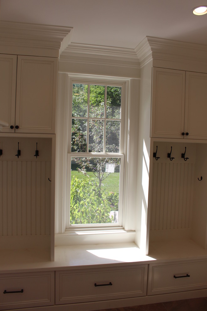 Transitional mudroom photo in Boston with white walls