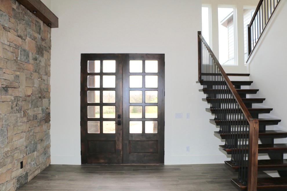 Immagine di una porta d'ingresso stile rurale di medie dimensioni con pareti bianche, parquet scuro, una porta a due ante, una porta in vetro e pavimento marrone