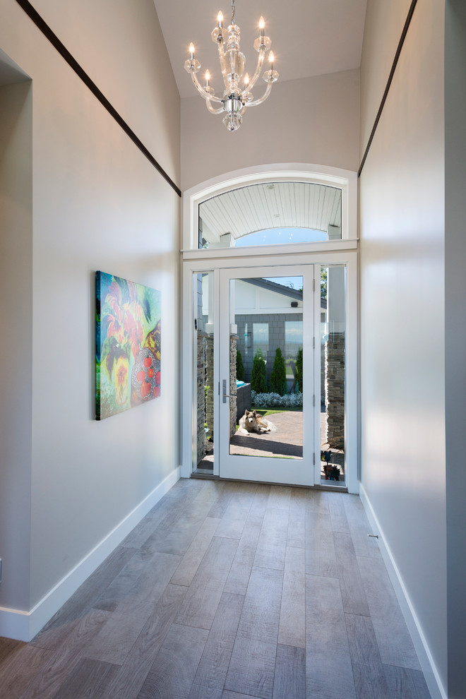Inspiration for a mid-sized transitional porcelain tile entryway remodel in Vancouver with gray walls and a glass front door