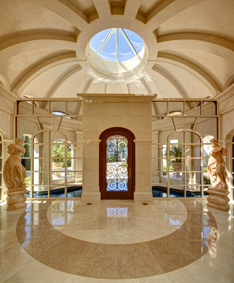 Idée de décoration pour un hall d'entrée méditerranéen avec un mur beige, une porte simple et une porte en verre.