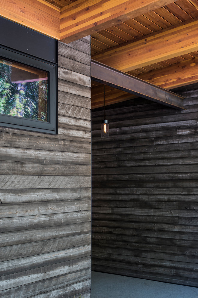 Inspiration for a mid-sized rustic concrete floor vestibule remodel in Seattle with gray walls
