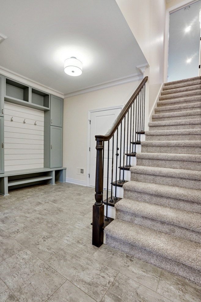 Large elegant laminate floor and gray floor entryway photo in Detroit with beige walls and a white front door