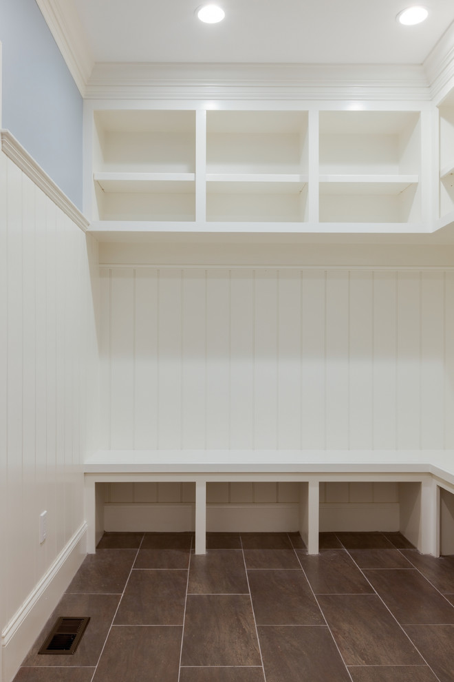 Inspiration for a mid-sized transitional porcelain tile mudroom remodel in Boston with white walls