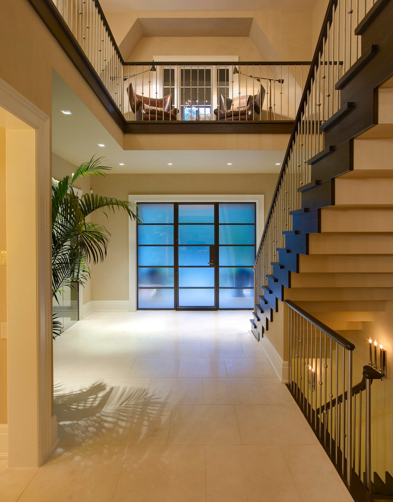 This is an example of a contemporary foyer in Detroit with beige walls, a single front door and a glass front door.