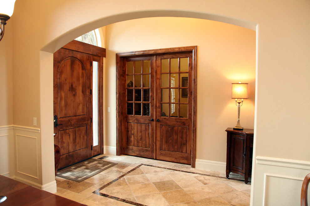 This is an example of a medium sized traditional foyer in Salt Lake City with beige walls, porcelain flooring, a single front door and a medium wood front door.