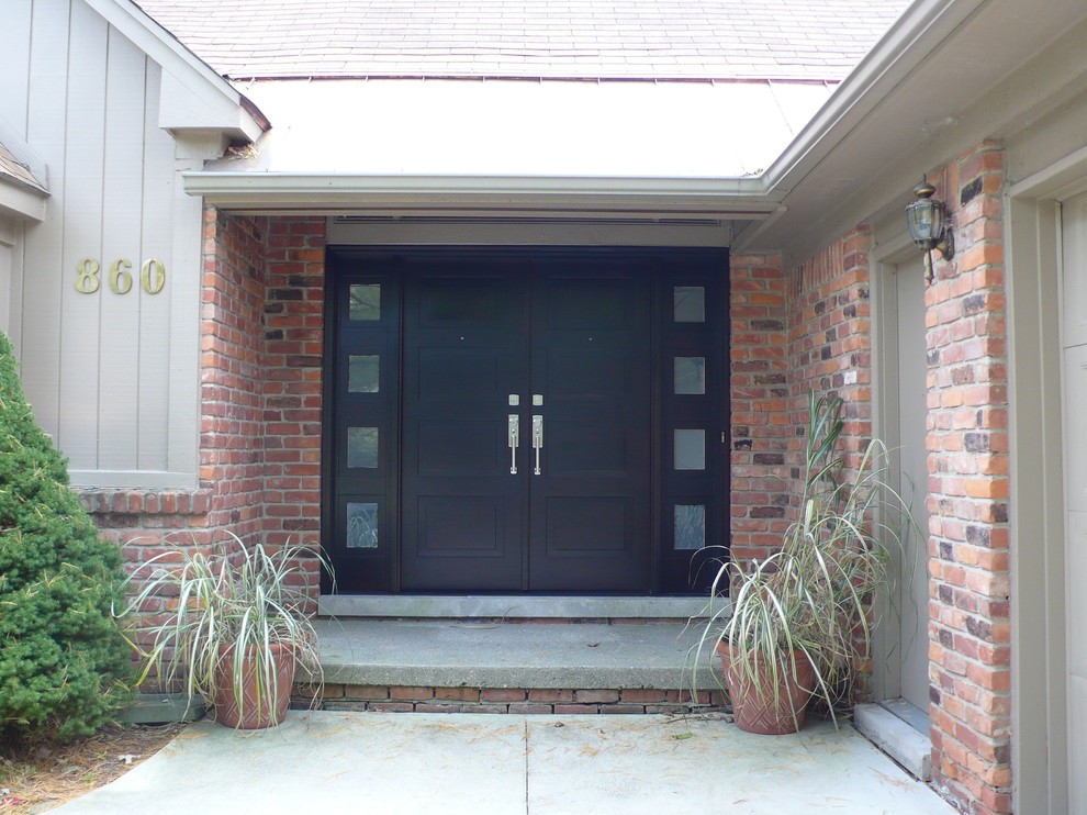 Inspiration for a contemporary double front door remodel in Detroit with a black front door