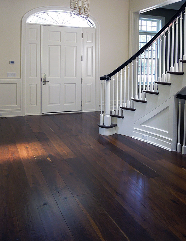 Entryway - large contemporary brown floor and dark wood floor entryway idea in Chicago with white walls and a white front door