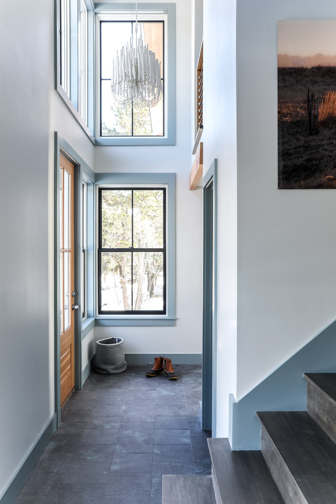 Entryway - mid-sized coastal slate floor and gray floor entryway idea in Portland Maine with white walls and a medium wood front door