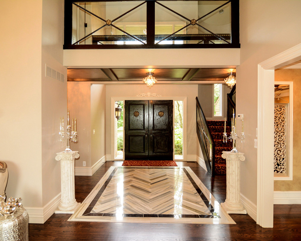 Entryway - eclectic marble floor entryway idea in Detroit with a dark wood front door