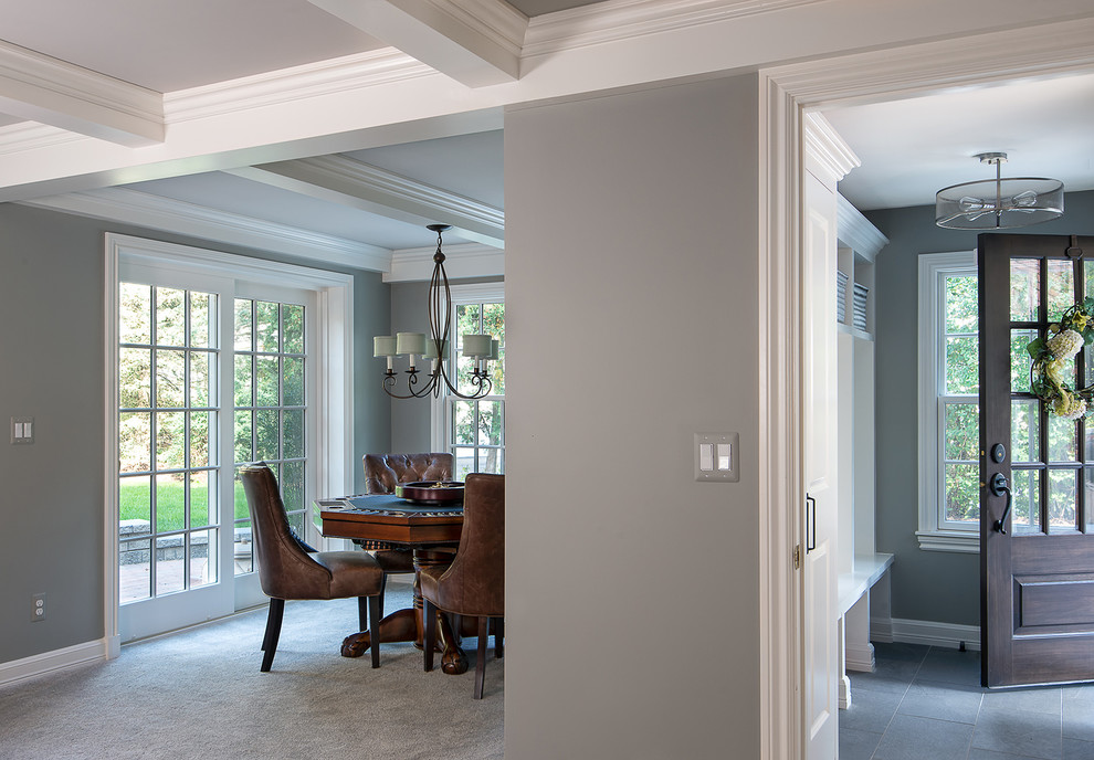 Example of a mid-sized transitional gray floor and ceramic tile entryway design in Detroit with gray walls and a dark wood front door
