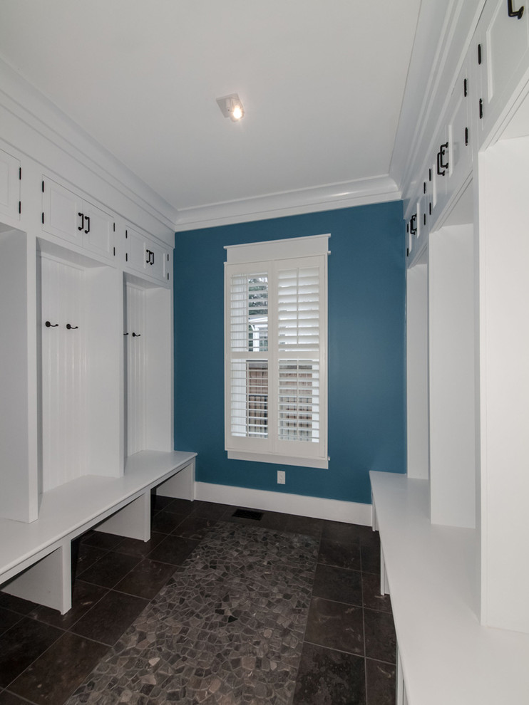 Photo of a large traditional foyer in DC Metro with blue walls, porcelain flooring, a single front door and a white front door.