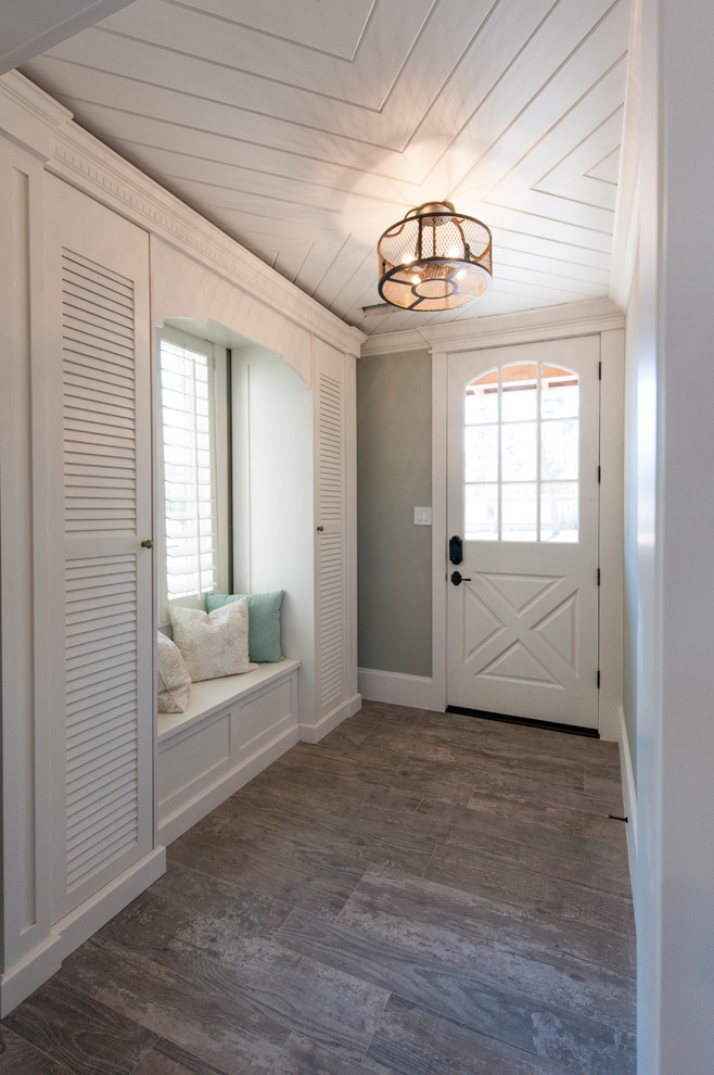 Inspiration for a beach style foyer in Houston with grey walls, medium hardwood flooring, a single front door, a white front door, brown floors, feature lighting and a timber clad ceiling.