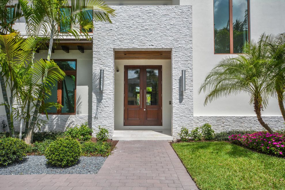 Inspiration for a large contemporary front door in Miami with white walls, a double front door and a dark wood front door.