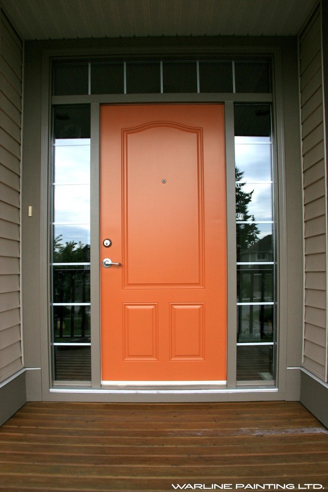 Inredning av en ingång och ytterdörr, med grå väggar, en enkeldörr och en orange dörr