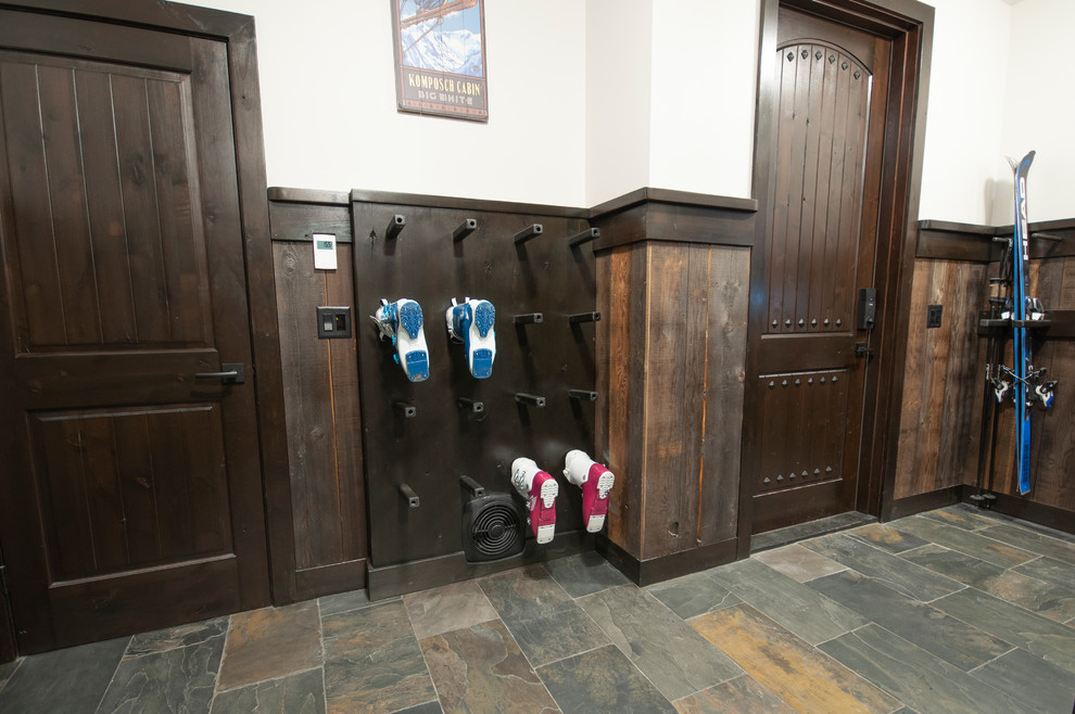 Large rustic boot room in Other with beige walls, slate flooring, a single front door, a dark wood front door, multi-coloured floors and a dado rail.