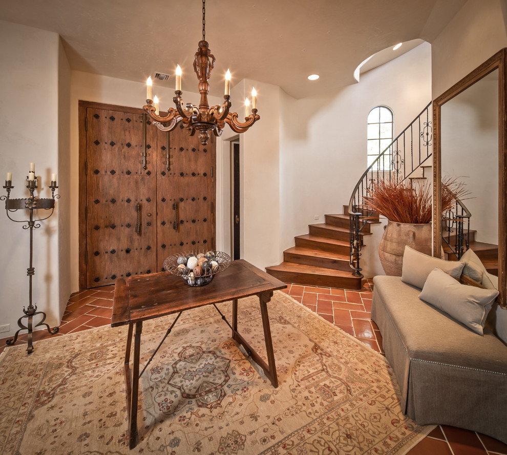 Example of a tuscan terra-cotta tile entryway design in Houston