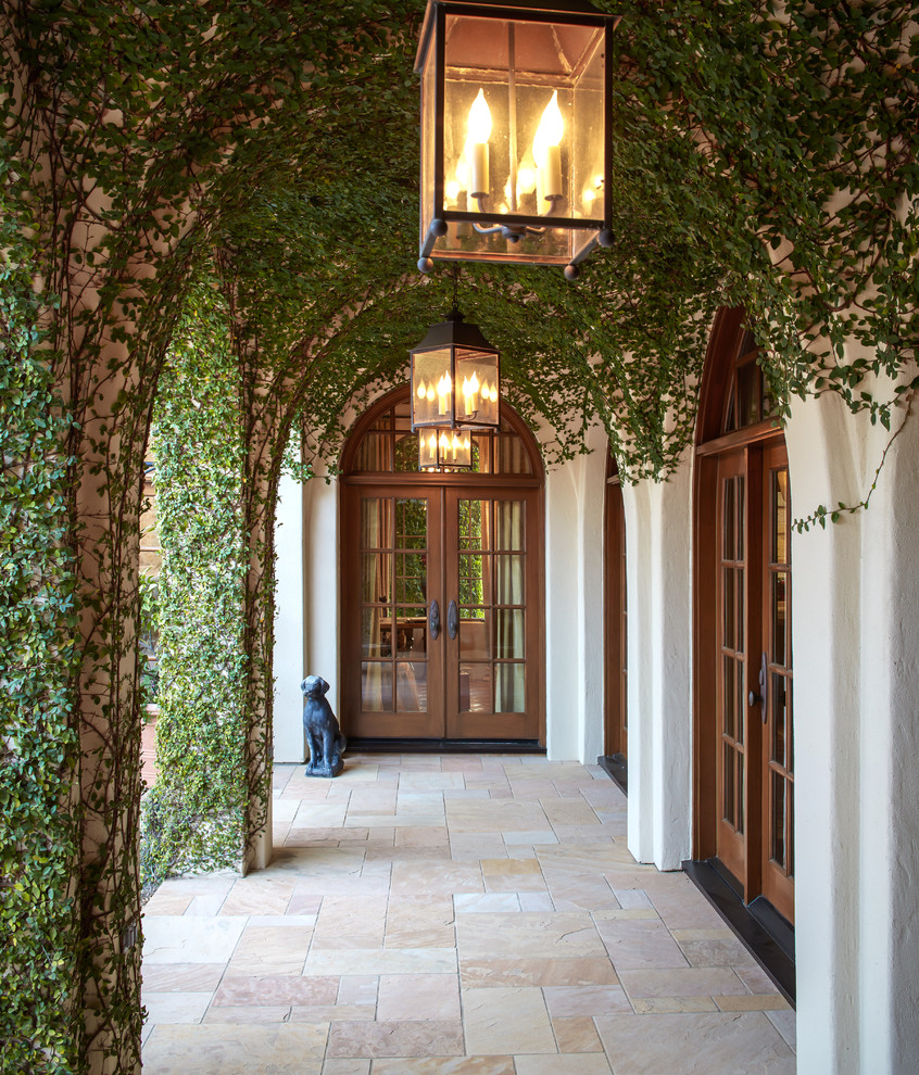 Inspiration for a mediterranean double front door remodel in Houston with a glass front door