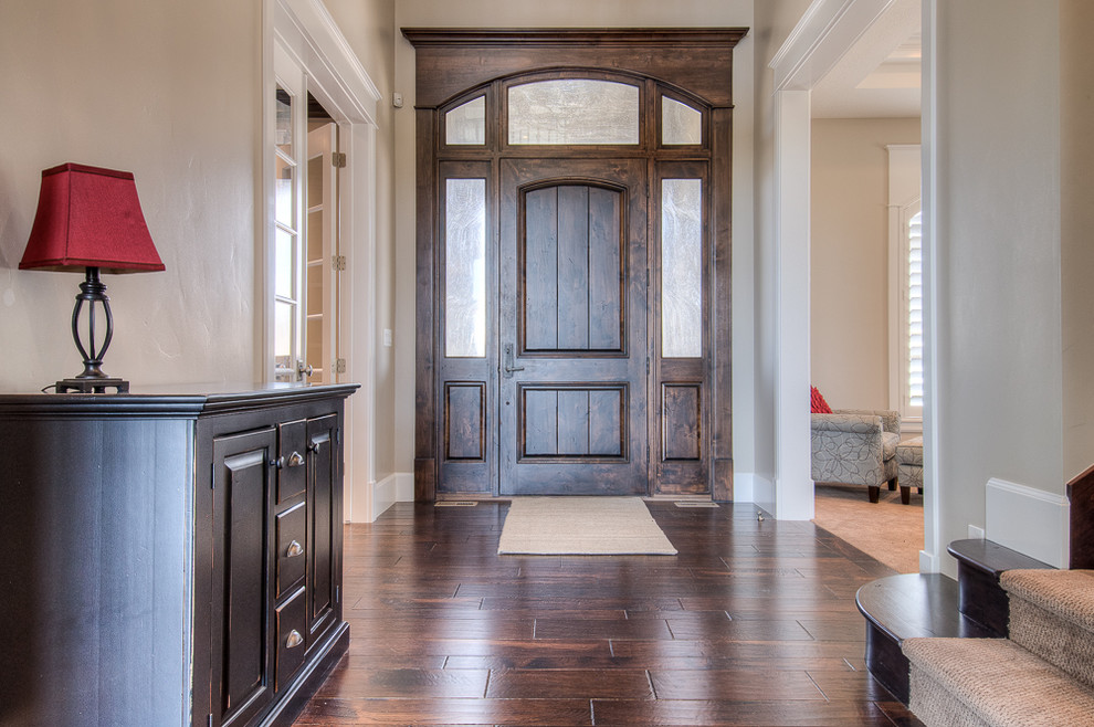Mid-sized elegant dark wood floor entryway photo in Salt Lake City with gray walls and a dark wood front door