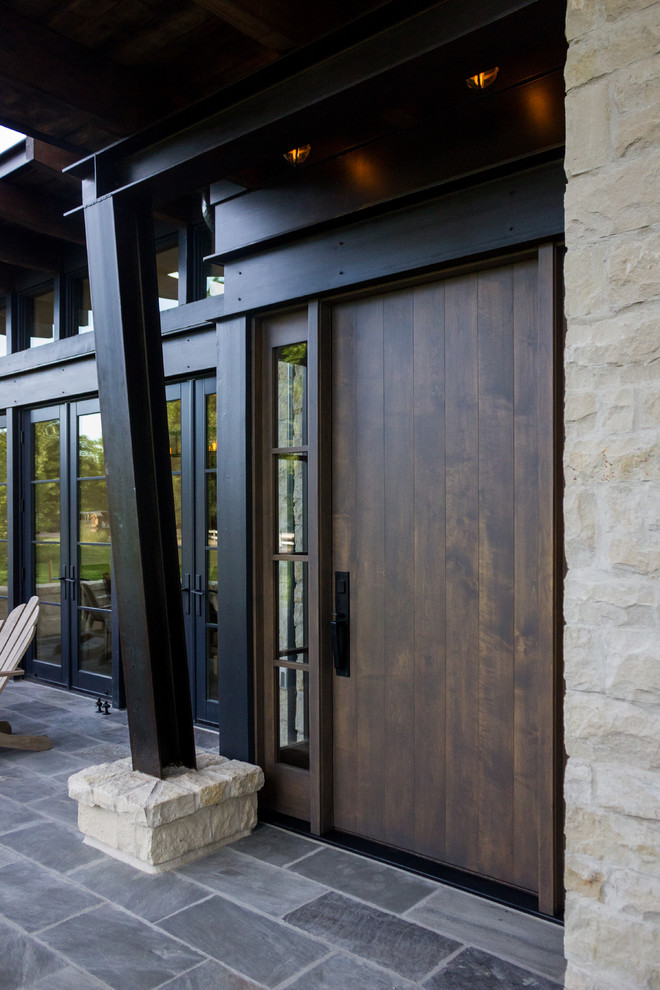 Example of a mid-sized minimalist entryway design in Denver with a dark wood front door