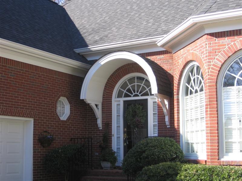 This is an example of a small traditional front door in Atlanta with a single front door and a black front door.