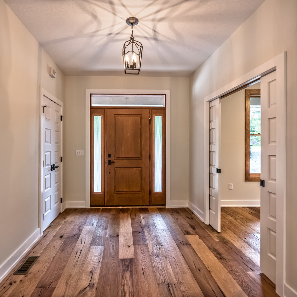 Large arts and crafts medium tone wood floor and brown floor entryway photo in Other with gray walls and a medium wood front door