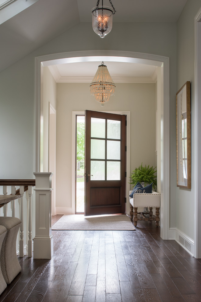 Inspiration for a mid-sized transitional dark wood floor and brown floor entryway remodel in Minneapolis with white walls and a glass front door