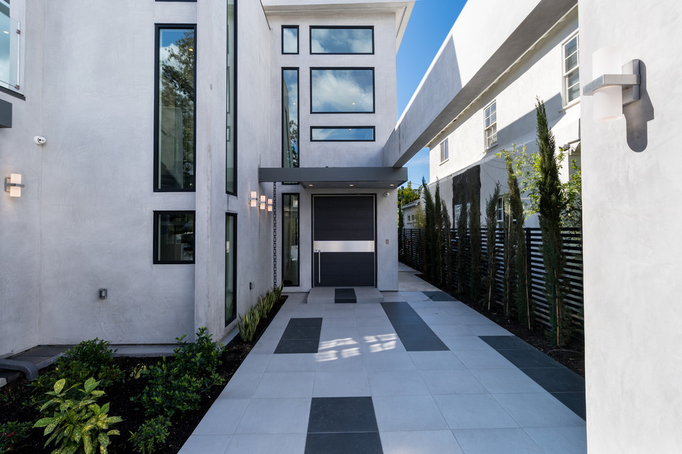 Example of a large trendy entryway design in Los Angeles with a black front door